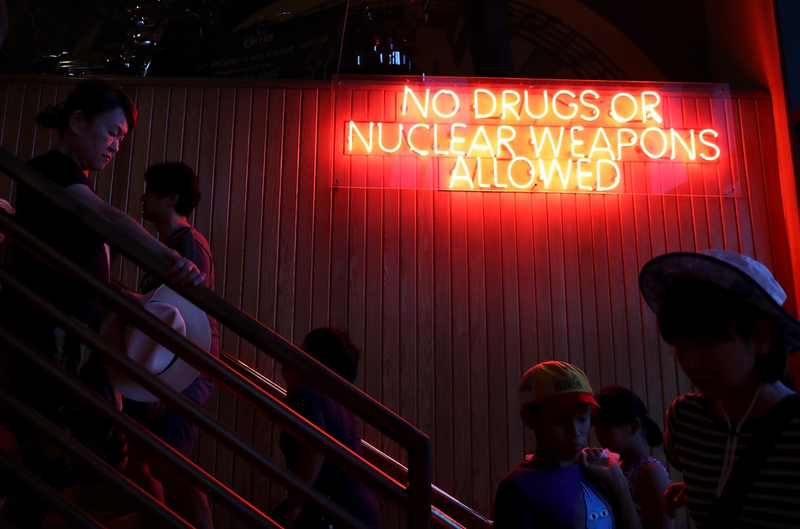 Customers walk by a neon sign at Hard Rock Cafe on August 15, 2017 in Tamuning, Guam. The American territory of Guam remains on high alert as a showdown between the U.S. and North Korea continues. (Photo by Justin Sullivan/Getty Images)